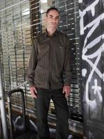 Picture of man in front of a gate