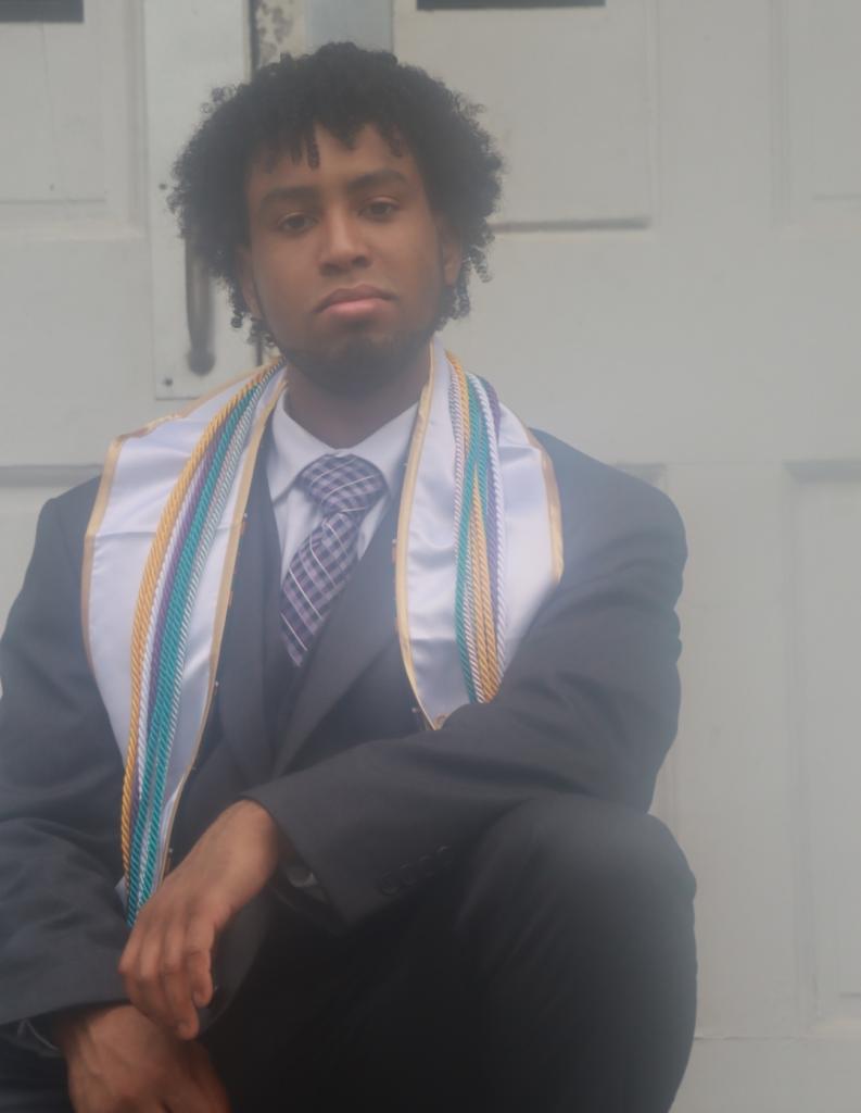 Hasan sitting on the steps of Graves Hall